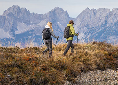A man and woman hiking with walking poles
